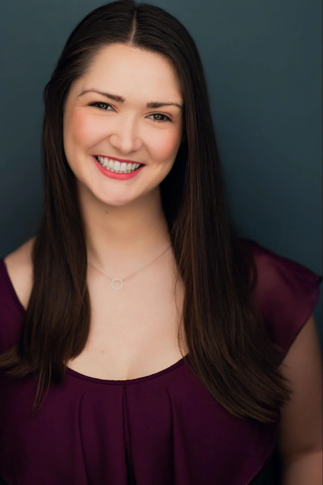 Veronica Murphy smiling in a plum top